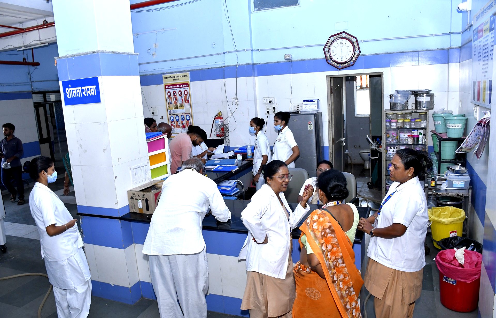 Nursing station with clinical staff in white coats attending to ward duties at RRSH Amravati