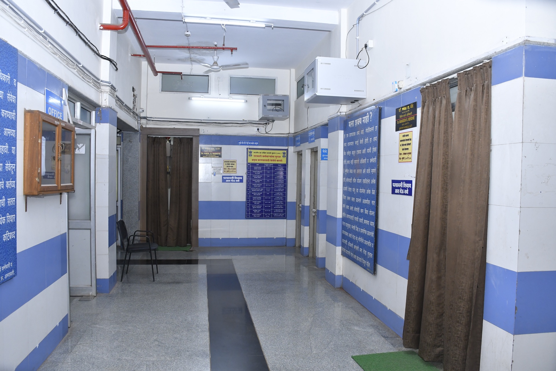 OPD corridor with blue and white tiled walls and information boards at RRSH Amravati