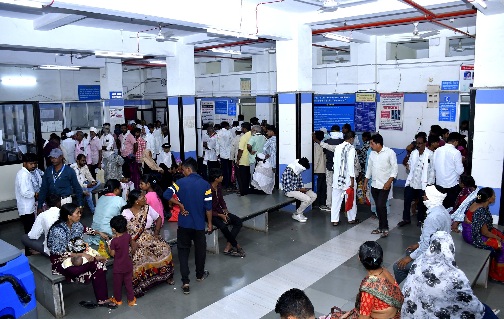 Packed OPD waiting hall at RRSH Amravati with patients queuing at service counters